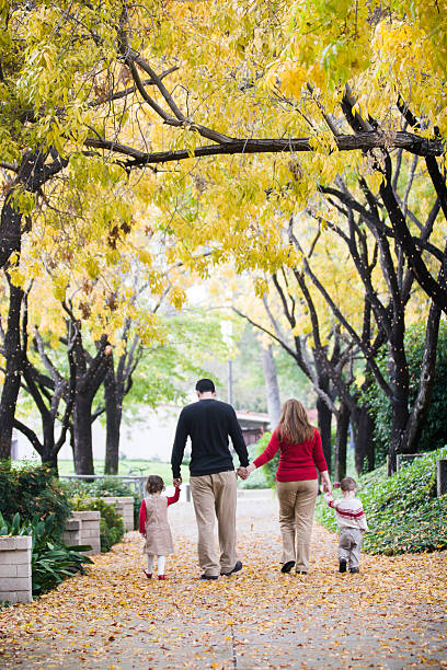 istock Christmas Family Walking Under Trees 598080200