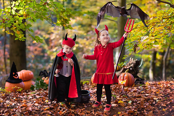 istock Kids wearing devil and vampire costume on Halloween 598081438