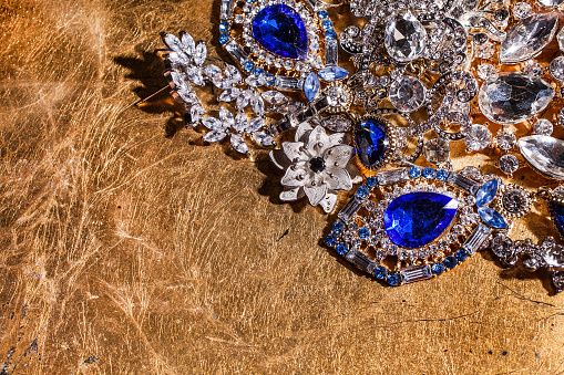 Precious luxury jewelry on shiny golden background