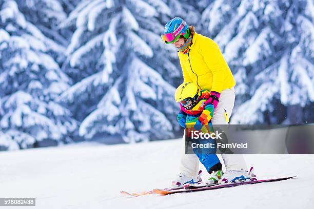 Active Mother And Little Boy Learning To Ski Stock Photo - Download Image Now - Skiing, Ski, Family