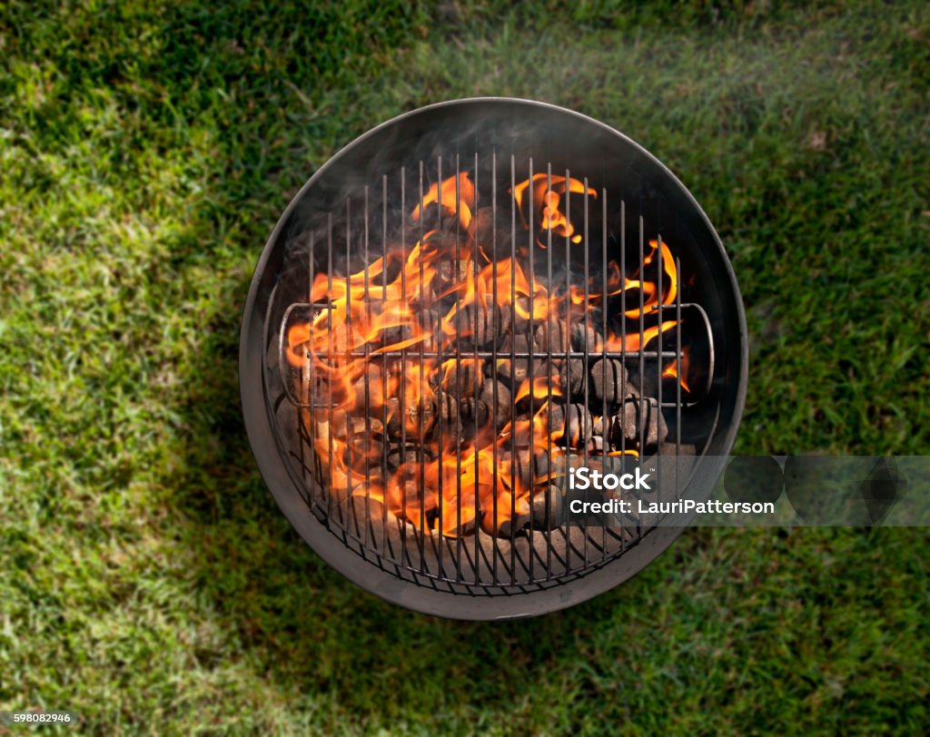 Charcoal BBQ in the Backyard on Grass Charcoal BBQ in the Backyard on Grass-Photographed on a Hasselblad H3D11-39 megapixel Camera System Barbecue Grill Stock Photo