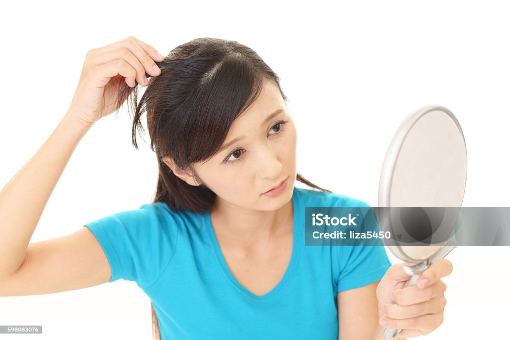 Woman with an uneasy look Woman look unhappy with her hair Gray Hair Stock Photo