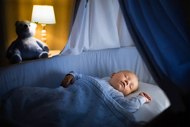 istock Adorable little baby boy sleeping at night 598083086