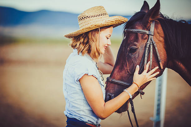 istock Young rider with cowboy hat and horse 598083612