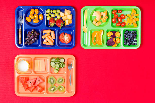 istock Three kids lunch trays with fruit 598085112