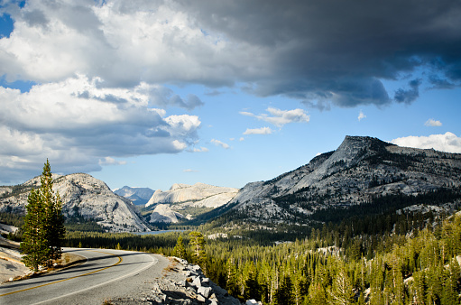 World famous Tioga Pass in Yosemite National Park with a dramatic cloudy sky.