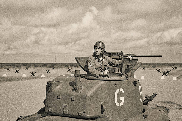World War 2 Armored Tank on Beach World War 2 M5 Stuart Tank and Tank Crew. 50 caliber machine gun. Anti tank obstacle on beach. Lots of extra bleed of multiple cropping options. weapon photos stock pictures, royalty-free photos & images
