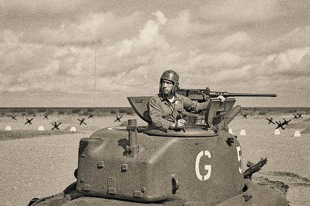 World War 2 Armored Tank on Beach World War 2 M5 Stuart Tank and Tank Crew. 50 caliber machine gun. Anti tank obstacle on beach. Lots of extra bleed of multiple cropping options. strong grain stock pictures, royalty-free photos & images