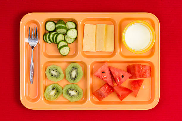 istock Lunch tray with fork, fruit, cheese and milk 598086490