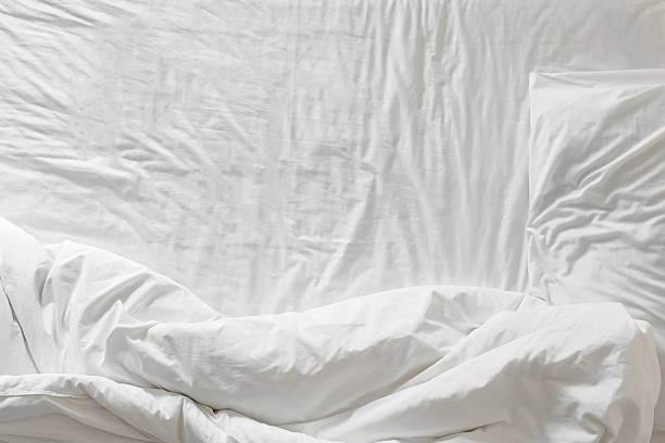Top view of white bedding and pillow at morning time