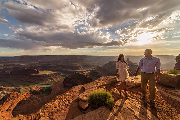 istock Bride & groom posing over vast canyons.  Utah desert, Moab. 598087970