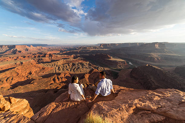 istock Bride & groom posing over vast canyons.  Utah desert, Moab. 598088004