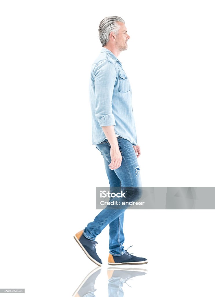 Casual man walking to the side Casual adult man in denim clothes walking to the side - isolated over a white background Walking Stock Photo