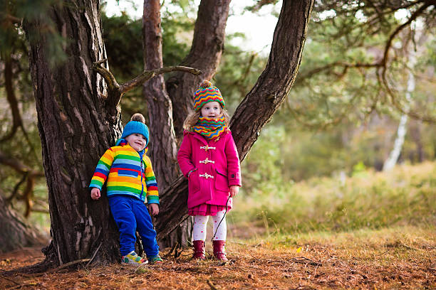 istock Kids playing in autumn park on cold day 598089974