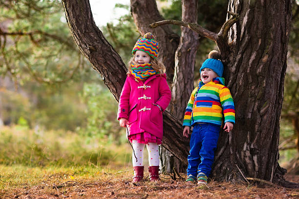 istock Kids playing in autumn park on cold fall day 598090468