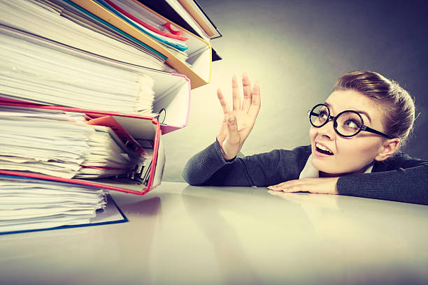 istock Accountant terrified of pils of binders. 598090918