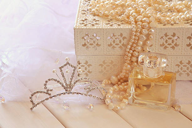 istock White pearls necklace, diamond tiara and perfume bottle 598092084
