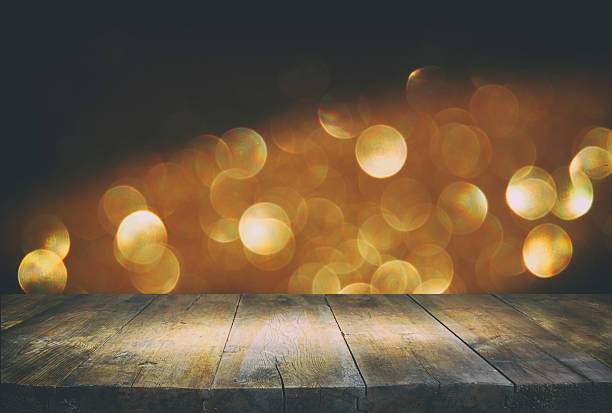 istock table in front of glitter lights background. De-focused 598092288