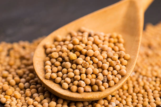 istock Spicy mustard seeds in a wooden background 598093176