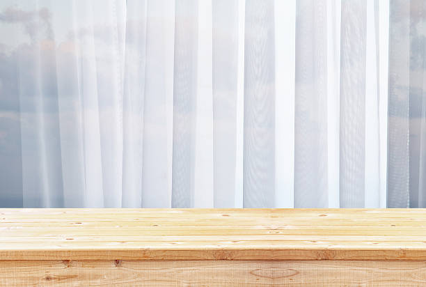istock image of wooden table in front of blurred window light 598093776