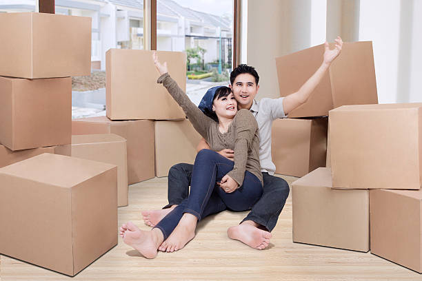 istock Happy couple with boxes in new house 598093982