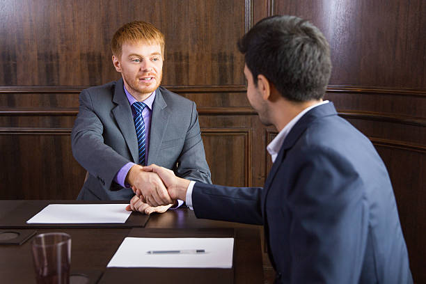 istock Young Caucasian Businessman Shaking Hands with Partner after Sig 598096434