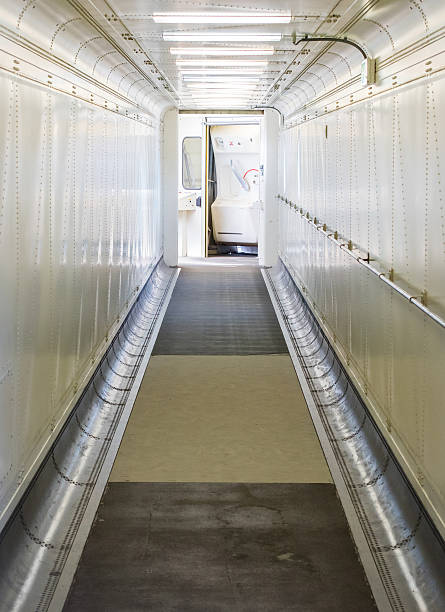 Jetway, walking towards the plane, selective focus Jetway, walking towards the plane, seeing the door of the plane, selective focus passenger boarding bridge stock pictures, royalty-free photos & images