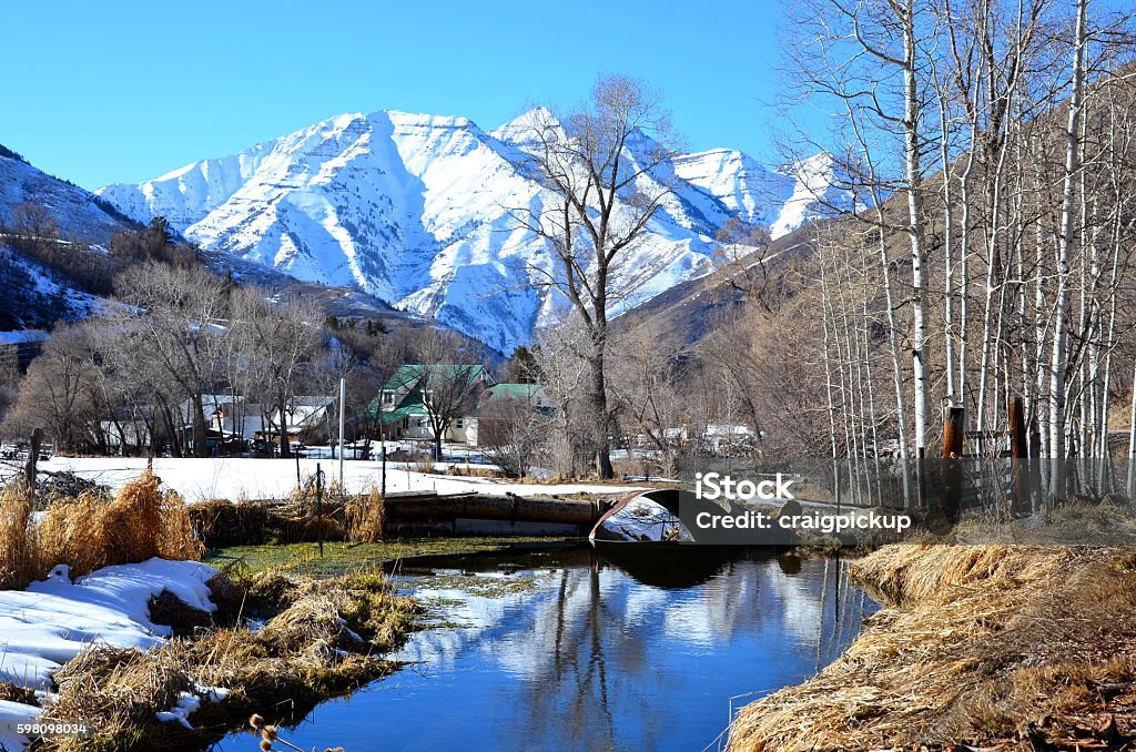 Mount Timpanogos Looking across the South Fork Provo River from the South Fork Road towards Mount Timpanogas, UT on a later winter day with clear blue skies. Provo Stock Photo