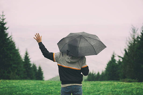 istock Man in nature holding umbrella. 598099868