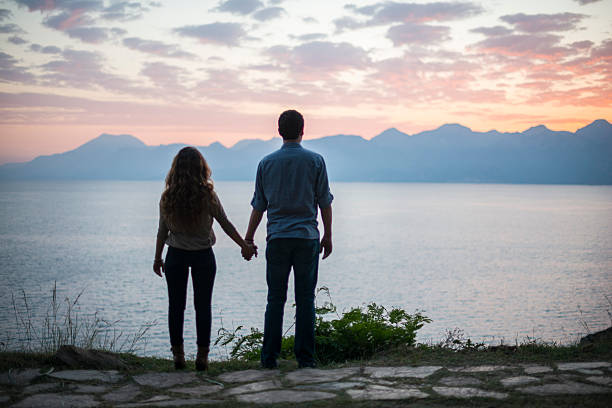 istock Portrait of young couple watching sunset 598130664