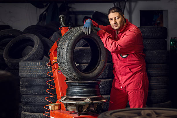 istock Mechanic replacing a tire on the wheel 598131386