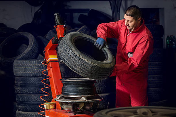 istock Mechanic replacing a tire on the wheel 598131424