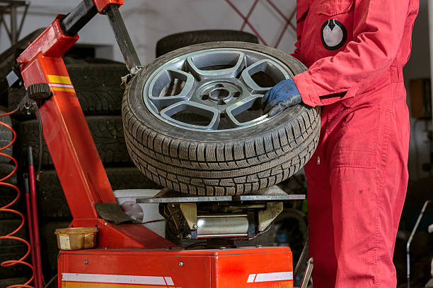 istock Mechanic replacing a tire on the wheel 598131704