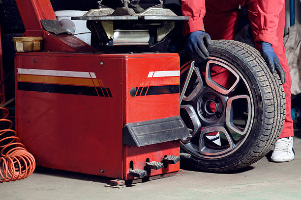 istock Mechanic replacing a tire on the wheel 598131750