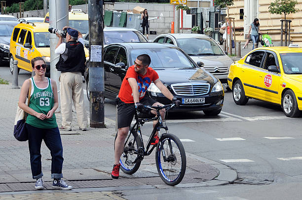 Sofia, Bulgaria - June 16, 2016: People and cars in the street of the city i thr summer