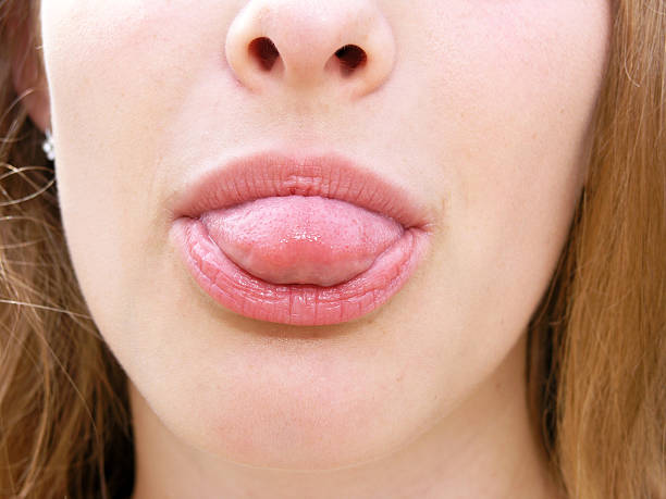 istock Young woman sticking tongue out 598132606