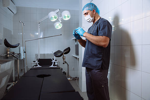 istock Young man surgeon takes on his protective glasses after operation 598133452