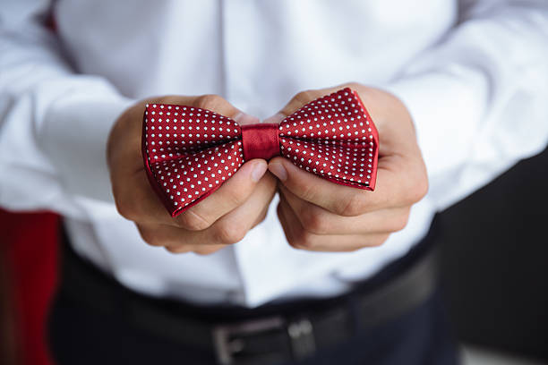 istock Man holding bow tie. Elegant gentleman clother. 598133876