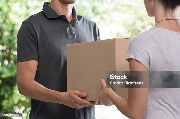 Courier Delivering Package Stock Photo - Download Image Now - Box - Container, Receiving, Holding