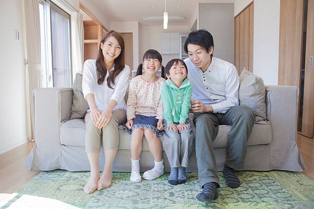istock Japanese family sitting on sofa 598134930