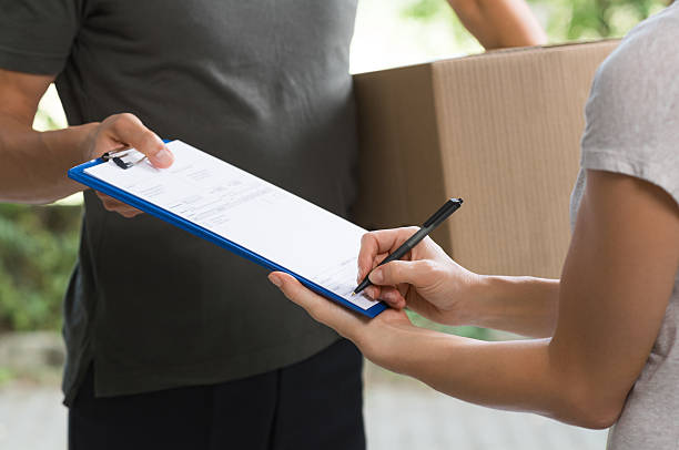 istock Woman signing delivery form 598134964