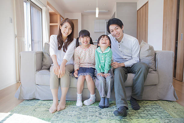 istock Japanese family sitting on sofa 598134970