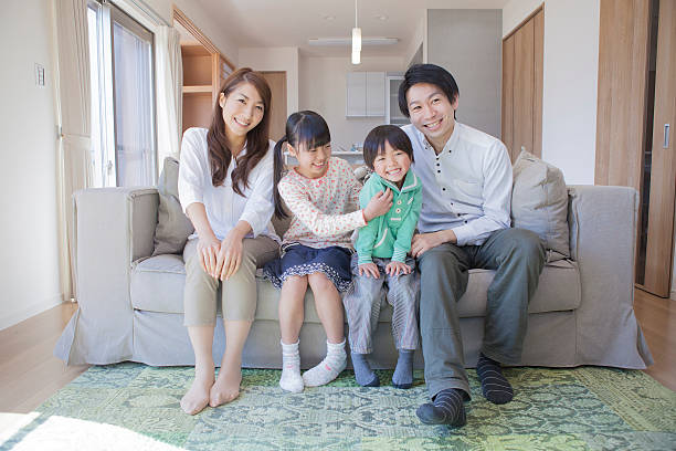 istock Japanese family sitting on sofa 598135036
