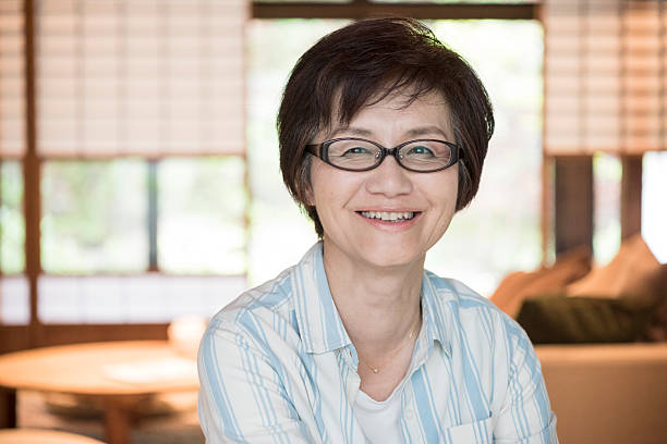 Portrait of happy mature Japanese woman Japanese woman wearing glasses looking at camera smiling one mature woman only stock pictures, royalty-free photos & images