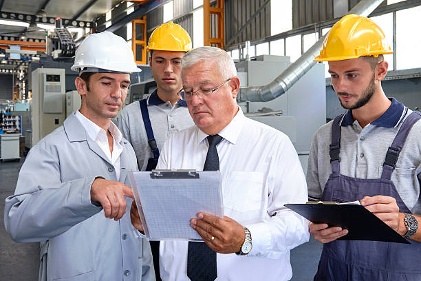 istock Supervisor and workers in factory 598138472