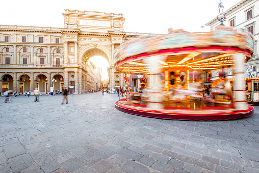 Republic square with the illuminated motion blurred carrousel in Florence