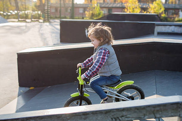 istock Little boy riding bicycle in skateboard park. 598139132