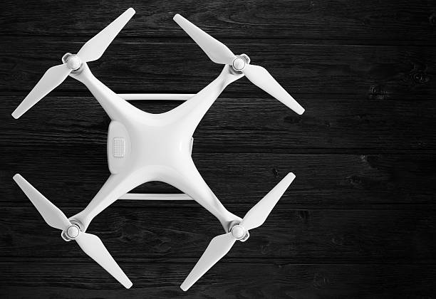 istock quadrocopter on a black wooden background 598140748
