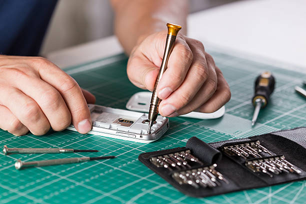 istock Man repairing broken smartphone, close up photo 598141022