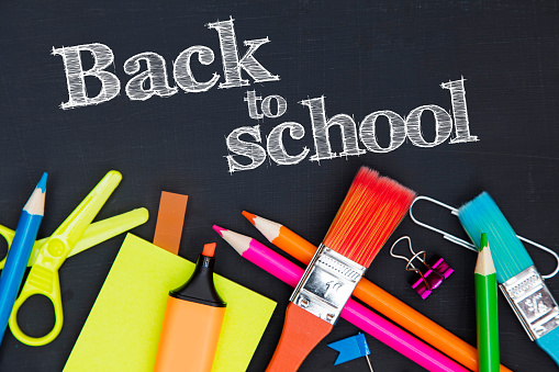 Back to school stationary  supplies on a chalkboard background